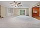 Spacious living room with built in shelving, carpet, and a view to the back yard at 1899 Stratford Arms Dr, Morrow, GA 30260