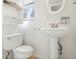 Bathroom featuring a pedestal sink, toilet, and built-in shelf, complemented by neutral tones at 281 Piedmont Ne Rd, Marietta, GA 30066