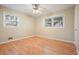 This is a cozy bedroom with natural light, wood flooring, and a ceiling fan at 281 Piedmont Ne Rd, Marietta, GA 30066