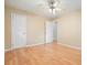 Bedroom with hardwood flooring featuring a ceiling fan and white doors with neutral wall paint at 281 Piedmont Ne Rd, Marietta, GA 30066