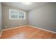 Cozy bedroom featuring a window and wood flooring at 281 Piedmont Ne Rd, Marietta, GA 30066