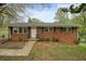 Charming one-story brick home with a manicured lawn and mature trees in a residential neighborhood at 281 Piedmont Ne Rd, Marietta, GA 30066