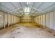 Large, open garage with a high ceiling, overhead lighting, and concrete floors at 281 Piedmont Ne Rd, Marietta, GA 30066