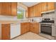 Functional kitchen featuring wood cabinets, stainless steel appliances, and neutral tile flooring at 281 Piedmont Ne Rd, Marietta, GA 30066