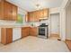 Functional kitchen featuring wood cabinets, stainless steel appliances, and neutral tile flooring at 281 Piedmont Ne Rd, Marietta, GA 30066