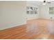 This empty living room boasts beautiful hardwood floors, and ample natural light from two large windows at 281 Piedmont Ne Rd, Marietta, GA 30066
