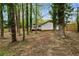 Spacious backyard with mature trees, newly installed privacy fence, and a deck for outdoor living at 3805 Cloudland Se Dr, Smyrna, GA 30082