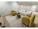 Finished basement featuring wood floors, white brick accent wall and contemporary yellow chairs at 3805 Cloudland Se Dr, Smyrna, GA 30082
