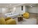 Open basement area furnished with stylish seating, wood side tables, and neutral carpet at 3805 Cloudland Se Dr, Smyrna, GA 30082