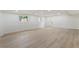 Finished basement with light wood floors, bright windows, and access door at 3805 Cloudland Se Dr, Smyrna, GA 30082