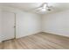 Finished basement with light wood floors, a ceiling fan, and a white brick wall at 3805 Cloudland Se Dr, Smyrna, GA 30082