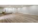 Spacious finished basement with light wood floors and white brick accent wall at 3805 Cloudland Se Dr, Smyrna, GA 30082