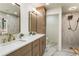 Elegant bathroom featuring double sinks, modern gold fixtures, and a spacious walk-in shower at 3805 Cloudland Se Dr, Smyrna, GA 30082