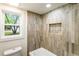 Shower/tub combo with tile surround, a built-in niche, and window at 3805 Cloudland Se Dr, Smyrna, GA 30082