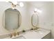 Bright bathroom with double vanity, white countertops, and gold fixtures at 3805 Cloudland Se Dr, Smyrna, GA 30082