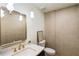 Bathroom with modern fixtures, a sink, toilet, and textured wall tiles at 3805 Cloudland Se Dr, Smyrna, GA 30082