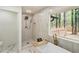 Luxurious bathroom showcasing a freestanding tub, a walk-in shower, and marble flooring at 3805 Cloudland Se Dr, Smyrna, GA 30082