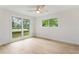 Bright bedroom with hardwood floors, a ceiling fan, and large windows with yard views at 3805 Cloudland Se Dr, Smyrna, GA 30082