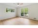 Serene bedroom with natural light, hardwood floors, and views of lush greenery at 3805 Cloudland Se Dr, Smyrna, GA 30082