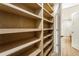 This closet has light wooden shelving and fixtures with a door opening to the rest of the house at 3805 Cloudland Se Dr, Smyrna, GA 30082
