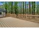 A large deck offers ample space for outdoor entertaining and relaxation with fenced area around the trees at 3805 Cloudland Se Dr, Smyrna, GA 30082
