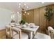 Bright dining room features stylish light fixture, wood accent wall and seating for six at 3805 Cloudland Se Dr, Smyrna, GA 30082