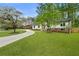 Charming renovated home with a sprawling green lawn and mature trees at 3805 Cloudland Se Dr, Smyrna, GA 30082