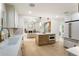 Modern kitchen featuring an island, stainless steel appliances, white cabinetry, and an open layout to the living space at 3805 Cloudland Se Dr, Smyrna, GA 30082
