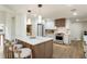 Bright kitchen features a spacious island with seating, modern appliances, and stylish pendant lighting at 3805 Cloudland Se Dr, Smyrna, GA 30082