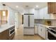 Well-designed kitchen features white cabinets and stainless steel appliances with modern fixtures at 3805 Cloudland Se Dr, Smyrna, GA 30082