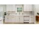 Bright kitchen features stainless steel appliances, white cabinetry, modern fixtures, and a view of the backyard at 3805 Cloudland Se Dr, Smyrna, GA 30082