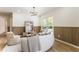 Bright living room with a modern chandelier, wood trim accent wall, and large windows at 3805 Cloudland Se Dr, Smyrna, GA 30082