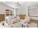 Bright living room with a modern chandelier, wet bar, wood trim accent wall, and large windows at 3805 Cloudland Se Dr, Smyrna, GA 30082