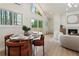 Bright living room features a dining area, access to a deck, and a cozy fireplace at 3805 Cloudland Se Dr, Smyrna, GA 30082