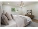 Comfortable bedroom featuring light wood floors, a serene color palette, and a decorative wood-toned dresser at 3805 Cloudland Se Dr, Smyrna, GA 30082