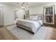 Stylish bedroom with light wood floors, a modern chandelier, and views of the outside at 3805 Cloudland Se Dr, Smyrna, GA 30082