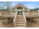 Rear elevation of a well maintained house featuring a large deck at 3805 Cloudland Se Dr, Smyrna, GA 30082