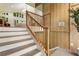 A modern staircase with wooden railing and stylish wood paneling at 3805 Cloudland Se Dr, Smyrna, GA 30082