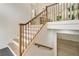 Well-lit staircase with wooden banister leading to the open-concept main floor at 3805 Cloudland Se Dr, Smyrna, GA 30082