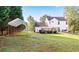 Backyard featuring a deck, a canopy-covered area, and a spacious lawn for outdoor activities at 4014 Ivy Trace Ln, Ellenwood, GA 30294