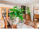 Bright dining room with a wooden table, classic decor, and views into the kitchen and living areas at 4014 Ivy Trace Ln, Ellenwood, GA 30294