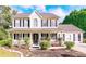 Charming two-story home with a welcoming front porch, manicured landscaping, and a classic colonial design at 4014 Ivy Trace Ln, Ellenwood, GA 30294