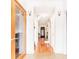Inviting hallway with gleaming hardwood floors, neutral walls, and decorative lighting at 4014 Ivy Trace Ln, Ellenwood, GA 30294