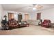Spacious living room with carpeted floors, comfortable seating, and neutral decor at 4014 Ivy Trace Ln, Ellenwood, GA 30294