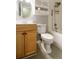 Bathroom featuring light wood vanity, oval mirror, toilet and a shower/tub combo at 771 Jordan Ln # K, Decatur, GA 30033