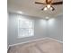 Bedroom with carpeting, window, ceiling fan with lighting, and gray paint at 771 Jordan Ln # K, Decatur, GA 30033