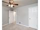 Cozy bedroom with neutral paint, a ceiling fan with lights, and two white doors for closet and exit at 771 Jordan Ln # K, Decatur, GA 30033