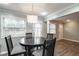 Dining area with a round table, modern light fixture, and windows at 771 Jordan Ln # K, Decatur, GA 30033