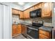 A functional kitchen with stainless steel appliances and wooden cabinets at 771 Jordan Ln # K, Decatur, GA 30033