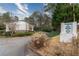 Townhomes of Druid Springs sign at the neighborhood entrance, landscaped with various trees at 771 Jordan Ln # K, Decatur, GA 30033